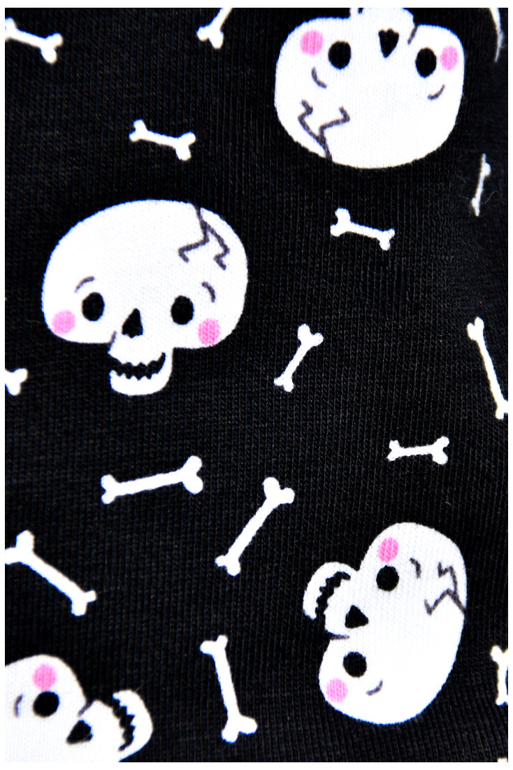 Black background white skull and small bones