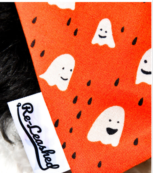 Orange background with small white ghost