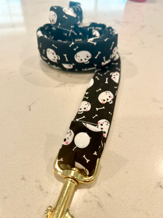 Skull and bone black leash cover on white surface