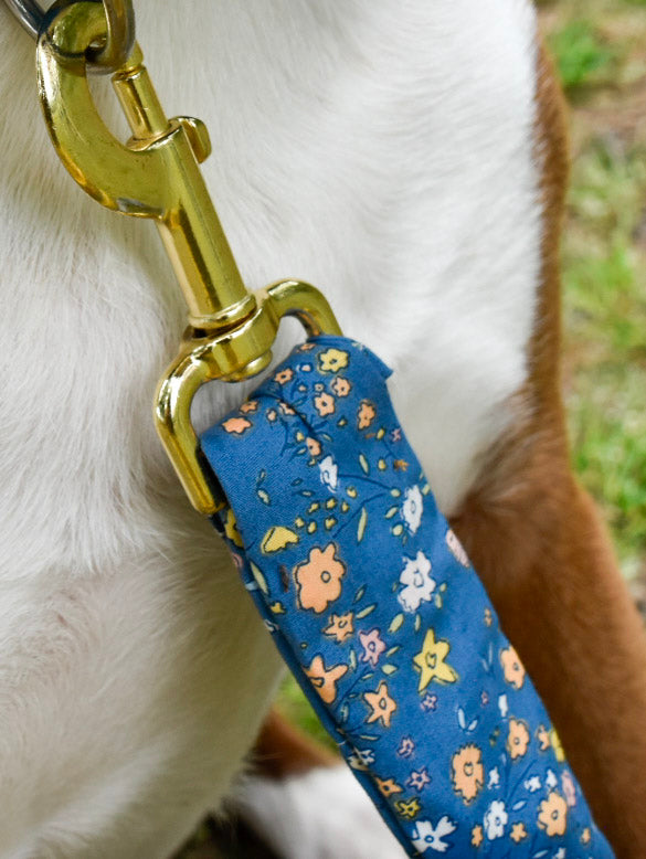 Close up blue floral bunny leash cover against dog chest 